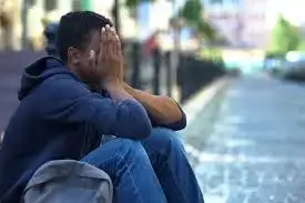 Young man overwhelmed with anxiety